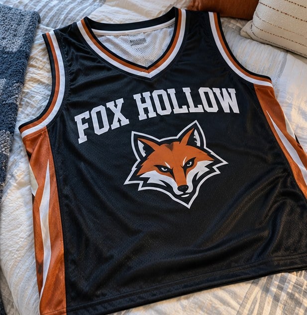 Customer photo of a custom basketball jersey on a bed